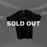 hands holding House of Exploration T-Shirt front with bold white lettering saying Sold Out